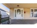 Classic front porch with a white door and stone lion statue at 839 N Oxford St, Indianapolis, IN 46201