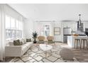 Bright, open living room with white walls, wood floors, and an adjacent kitchen at 1230 N Alabama St, Indianapolis, IN 46202