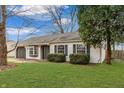 White ranch home with gray accents and mature trees at 282 N Wagon Rd, Bargersville, IN 46106