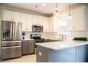 Modern kitchen with stainless steel appliances and gray and white cabinets at 3142 Autumn Run, Bargersville, IN 46106