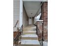 Steps leading to a white door on a covered porch at 415 N Hamilton Ave, Indianapolis, IN 46201