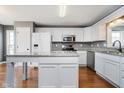 Modern kitchen with island, granite countertops, and stainless steel appliances at 5670 Gainesway Dr, Greenwood, IN 46142