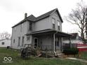 Two-story house with gray siding, front porch, and a wraparound porch at 205 S Arsenal Ave, Indianapolis, IN 46201