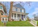 Two-story blue house with white porch and landscaping at 2230 E 12Th St, Indianapolis, IN 46201