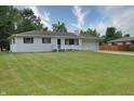 Ranch home with white brick exterior, attached garage, and spacious lawn at 3515 Lindbergh Dr, Indianapolis, IN 46237