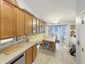 Eat-in kitchen with wooden table, glass-front cabinets, and yellow floral wallpaper at 7936 Yucca Ct, Camby, IN 46113