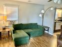 Living room featuring a green sectional sofa and hardwood floors at 2104 N Ball Ave, Muncie, IN 47304