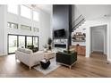 Spacious living room with a large fireplace, high ceilings, and lots of natural light at 5187 Abington Way, Zionsville, IN 46077