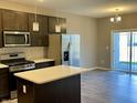 Modern kitchen with stainless steel appliances, island, and sliding door to patio at 2834 Maricopa Blvd, Whitestown, IN 46075