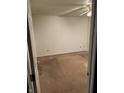 Empty carpeted bedroom with a ceiling fan and white walls at 5283 Tufton Dr, Indianapolis, IN 46254