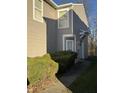 Side view of a tan house with green bushes and a walkway at 5283 Tufton Dr, Indianapolis, IN 46254