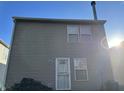 Rear view of a tan house with a door and two windows at 5283 Tufton Dr, Indianapolis, IN 46254