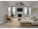 Bright living room features a neutral color palette, fireplace, and ample natural light at 5817 Cool Hollow Way, Indianapolis, IN 46237