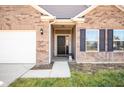 Inviting front entrance with a dark-colored door and brick accents at 6182 N Caraway Dr, McCordsville, IN 46055