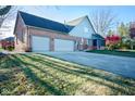 Three-car garage and side yard of home at 7708 Ballyshannon St, Indianapolis, IN 46217