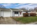 Ranch home with attached garage and driveway at 8016 Minlo Dr, Indianapolis, IN 46227