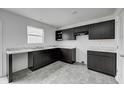 Modern kitchen featuring dark cabinets and marble countertops at 1126 Lona Dr, Martinsville, IN 46151