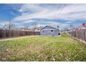 Spacious backyard with grassy area and a partially visible home at 1436 W 5Th St, Anderson, IN 46016