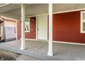 Quaint front porch with white columns and a concrete floor at 1467 S Illinois St, Indianapolis, IN 46225