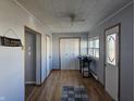 Welcoming entryway with wood-look flooring and a door with a decorative glass insert at 1517 N E St, Elwood, IN 46036