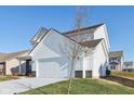 Two-story white house with gray brick accents and a two-car garage at 1795 N Rapids Ct, Greenfield, IN 46140