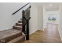 Modern staircase with dark wood railing and carpeted steps at 1795 N Rapids Ct, Greenfield, IN 46140