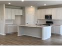 Modern kitchen featuring white cabinets, quartz countertops, and an island at 6862 Bridle Oaks Ct, Whitestown, IN 46075