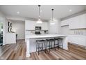 Modern kitchen with white cabinets, quartz countertops and a large island with seating at 6862 Bridle Oaks Ct, Whitestown, IN 46075