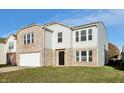 Two-story brick and vinyl home with a white garage door and landscaping at 8442 Burket Way, Camby, IN 46113