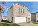 Brick and vinyl home with a white garage door and partial yard view at 8442 Burket Way, Camby, IN 46113