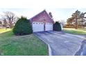 Two-car brick garage with a large driveway at 1500 S Anderson St, Elwood, IN 46036