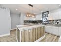 Modern kitchen with white cabinets, granite countertops, and a large island at 2318 E Brookside Ave, Indianapolis, IN 46218