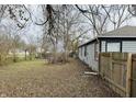 Large backyard with wooden fence and mature trees at 3206 W 57Th St, Indianapolis, IN 46228