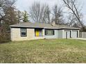 Ranch home with stone exterior, attached two-car garage, and landscaped lawn at 3206 W 57Th St, Indianapolis, IN 46228