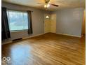 Hardwood floors and a cozy fireplace in this spacious living room at 3206 W 57Th St, Indianapolis, IN 46228