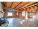 Bright living room with log cabin features and wood floors at 4298 W 300 N, Anderson, IN 46011