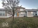 Spacious backyard with a patio and a tree, surrounded by a wooden fence at 581 Beehler Dr, Whiteland, IN 46184