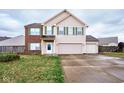 Two-story house with brick and beige siding, two-car garage, and landscaped yard at 8231 Golden Ridge Ln, Indianapolis, IN 46237