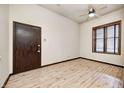 Simple bedroom with hardwood floors and a large window at 1404 Broadway St # Apt A, Indianapolis, IN 46202
