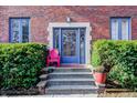 Brick building entrance with steps and landscaping at 1404 Broadway St # Apt A, Indianapolis, IN 46202