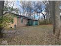 Back of the house showing a brown exterior with a partially visible green structure at 17531 Joliet Rd, Westfield, IN 46074