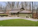 Green house with brown roof, attached garage, and grassy yard at 1850 White Oak W Ln, Martinsville, IN 46151