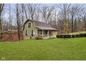 Green house with brown roof and a yard at 1850 White Oak W Ln, Martinsville, IN 46151