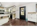 Galley kitchen with white cabinets, dark floors, and island at 1850 White Oak W Ln, Martinsville, IN 46151