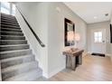 Bright foyer with gray carpet stairs and a wooden console table at 1486 Covington Blvd, Franklin, IN 46131