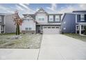 Two-story home with gray siding, brick accents, and a two-car garage at 19971 Edwick Dr, Westfield, IN 46074