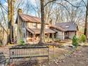 Rustic log home exterior showcasing a charming front porch and landscaping at 3499 Raspberry Ln, Nineveh, IN 46164