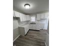 White cabinets, double sink, vinyl flooring at 3771 Creston Dr, Indianapolis, IN 46222