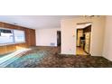 Spacious living room with adjacent kitchen and vintage carpeting at 8315 Woodall Dr, Indianapolis, IN 46268