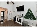 Living room featuring a wall-mounted TV and a decorated artificial Christmas tree at 10816 Bellflower Ct, Indianapolis, IN 46235